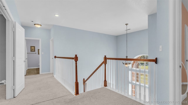 corridor with light colored carpet