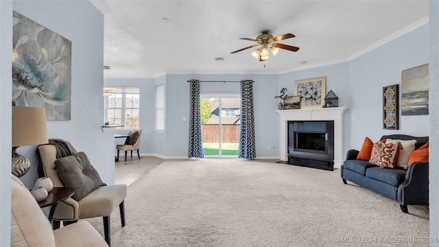 carpeted living room with a fireplace, ceiling fan, and crown molding