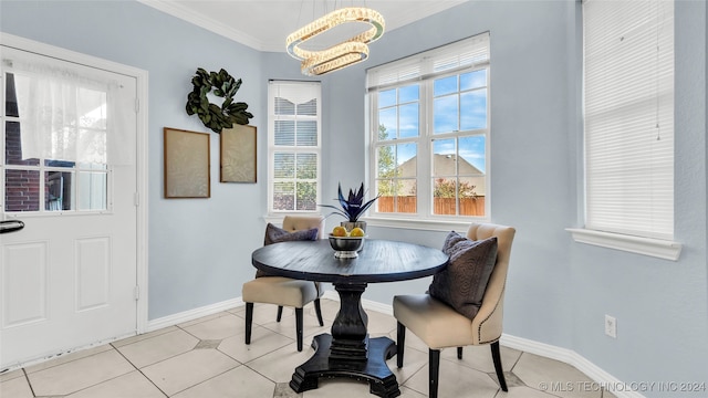 dining space with ornamental molding, a chandelier, and light tile patterned flooring