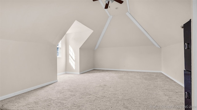 additional living space with vaulted ceiling, ceiling fan, and carpet flooring