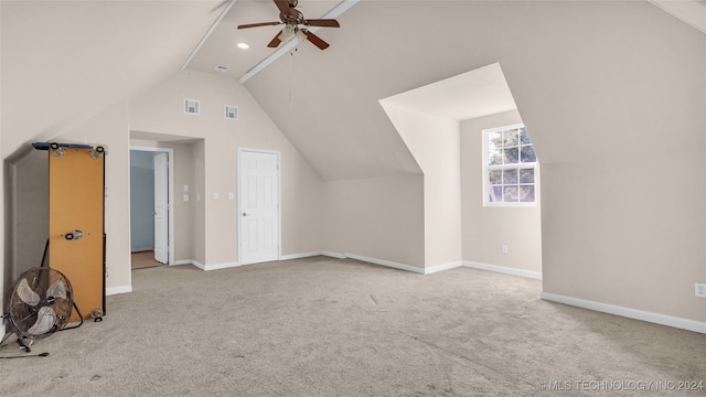 additional living space featuring vaulted ceiling, ceiling fan, and light colored carpet