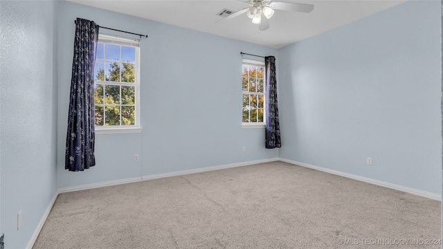 unfurnished room with ceiling fan and carpet floors