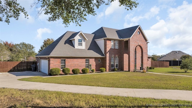 front facade featuring a front lawn and a garage