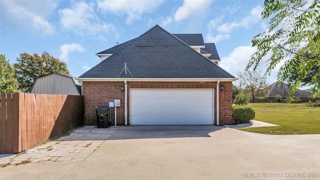 exterior space with a yard and a garage