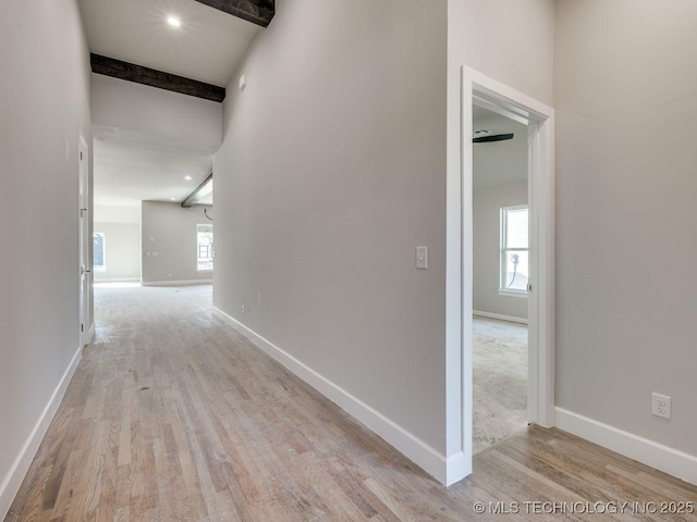 hallway with beam ceiling and light wood-type flooring