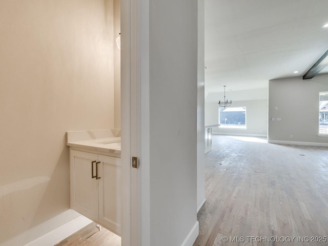 bathroom featuring hardwood / wood-style flooring, vanity, and a chandelier