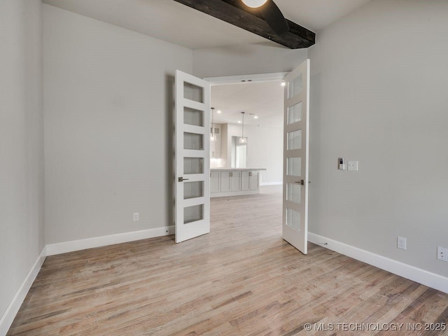 unfurnished room featuring light hardwood / wood-style floors and french doors