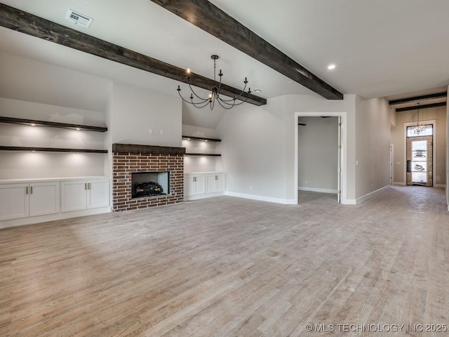 unfurnished living room featuring a brick fireplace, light hardwood / wood-style flooring, and built in features