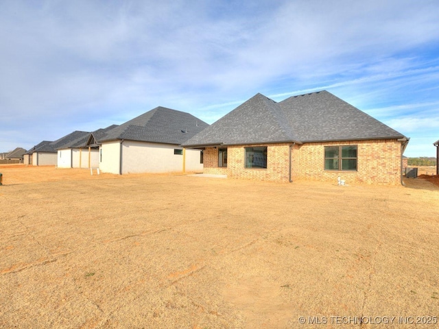 rear view of property featuring a yard