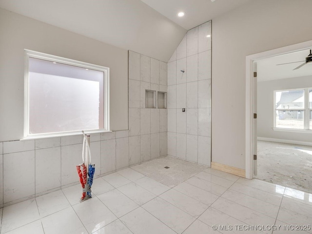 bathroom featuring ceiling fan, tile patterned floors, and vaulted ceiling