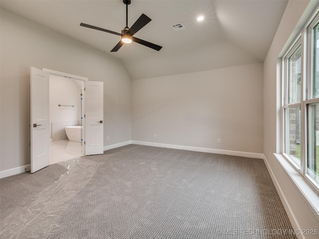 unfurnished bedroom featuring vaulted ceiling, visible vents, baseboards, and carpet