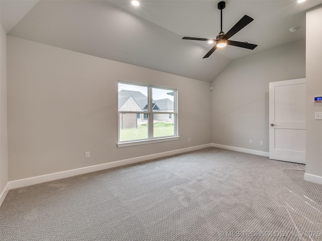 spare room with recessed lighting, vaulted ceiling, a ceiling fan, carpet floors, and baseboards