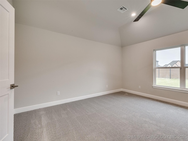 carpeted empty room with recessed lighting, vaulted ceiling, visible vents, baseboards, and ceiling fan