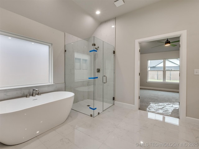 full bathroom with a freestanding bath, baseboards, marble finish floor, and a stall shower