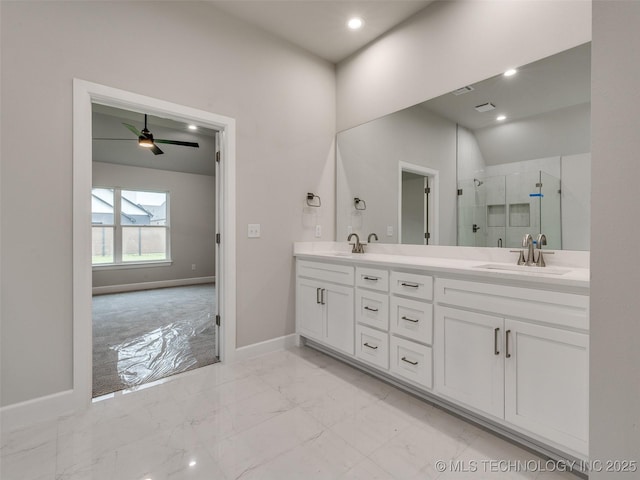 full bath featuring a sink, double vanity, baseboards, marble finish floor, and a shower stall