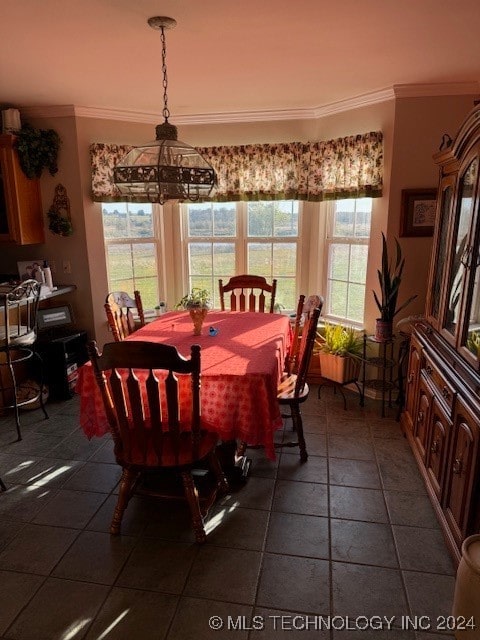 dining room featuring an inviting chandelier, a wealth of natural light, and ornamental molding