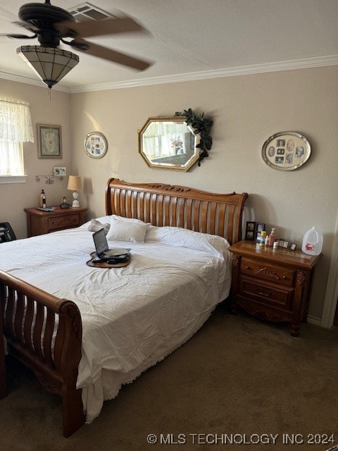 bedroom featuring ceiling fan, crown molding, and dark colored carpet