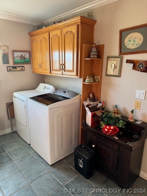 washroom with cabinets, ornamental molding, and washing machine and dryer