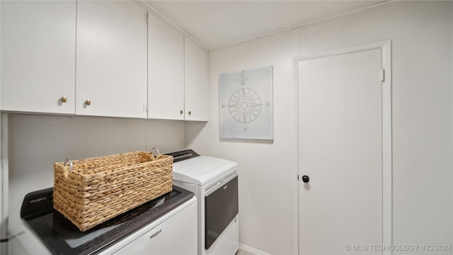 washroom featuring cabinets and independent washer and dryer