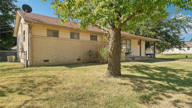 view of front of house with central AC and a front yard