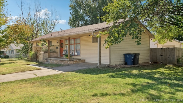 view of front of house with a porch and a front lawn