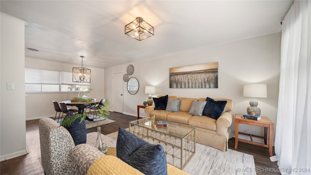 living room featuring dark hardwood / wood-style flooring and a notable chandelier