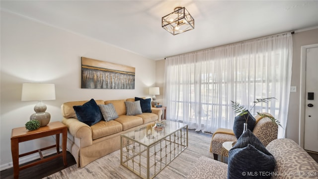 living room with hardwood / wood-style floors and an inviting chandelier