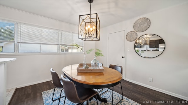 dining space featuring crown molding, dark hardwood / wood-style floors, and an inviting chandelier