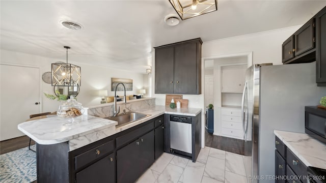 kitchen with decorative light fixtures, kitchen peninsula, sink, and stainless steel appliances