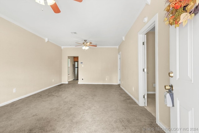 carpeted empty room with ceiling fan and crown molding