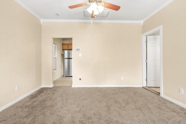 spare room with ceiling fan, light colored carpet, and ornamental molding