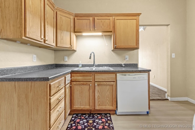 kitchen featuring sink, white dishwasher, and light hardwood / wood-style floors