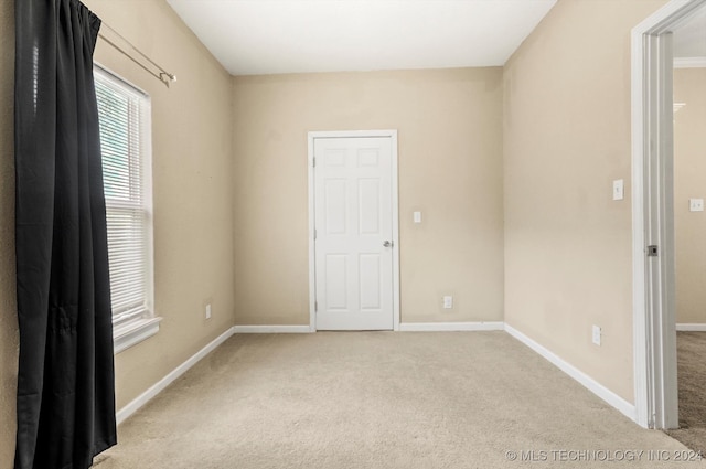 empty room featuring light colored carpet