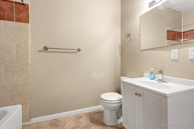 bathroom featuring tile patterned floors, vanity, and toilet