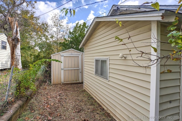 view of home's exterior with a storage shed