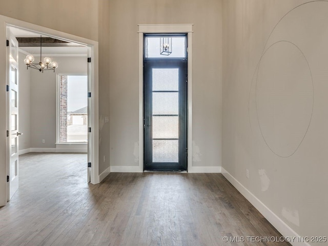 entrance foyer with a chandelier and hardwood / wood-style floors