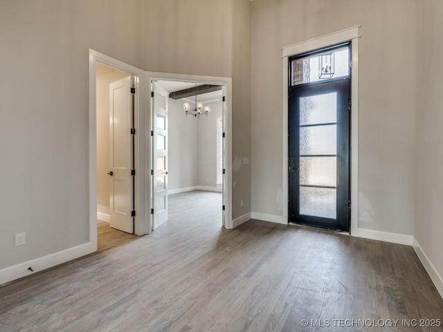 entryway with a chandelier and light hardwood / wood-style flooring