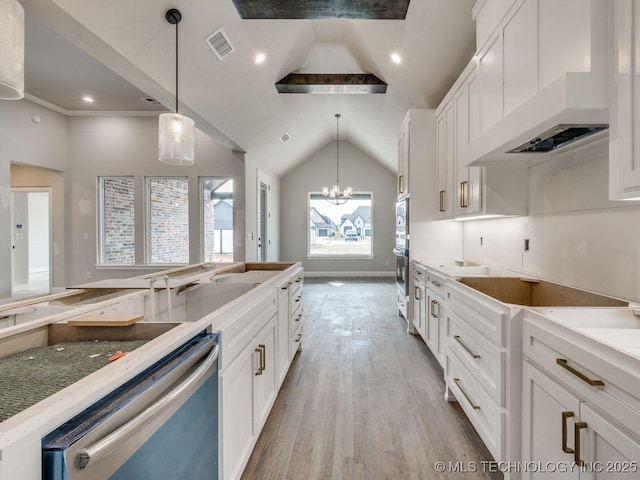 kitchen with white cabinetry, pendant lighting, premium range hood, and stainless steel dishwasher