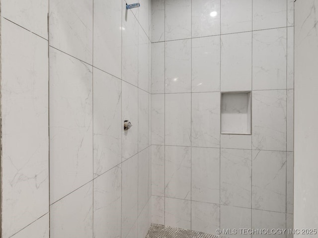 bathroom with tiled shower