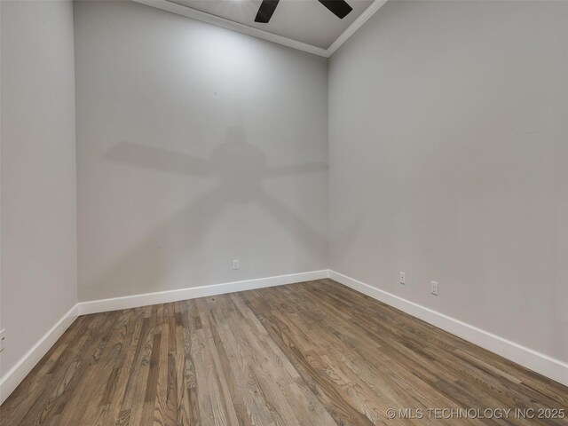 unfurnished room with wood finished floors, baseboards, ornamental molding, and a ceiling fan