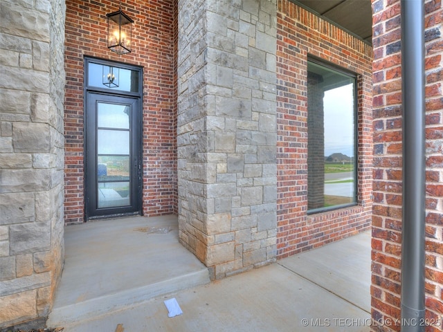 entrance to property with brick siding and stone siding
