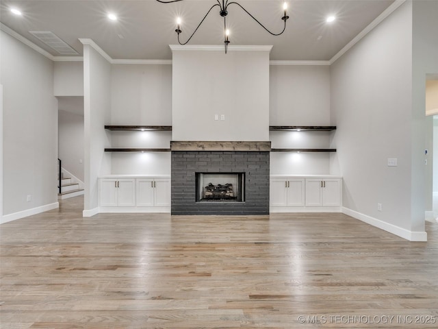 unfurnished living room featuring recessed lighting, light wood-style flooring, and stairway