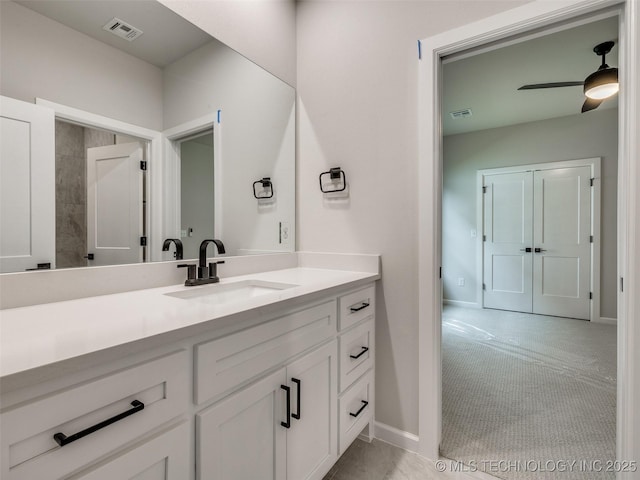 bathroom featuring baseboards, visible vents, vanity, and ceiling fan