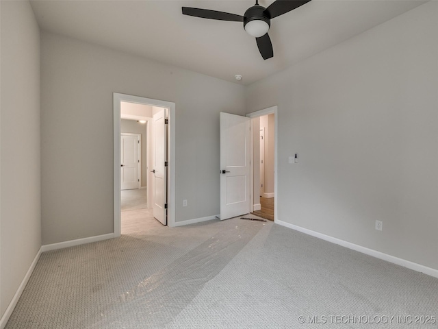 unfurnished bedroom with ceiling fan, light carpet, and baseboards