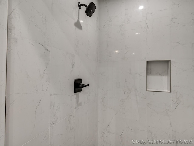 interior details with a tile shower
