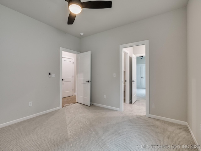 unfurnished bedroom with baseboards, light colored carpet, and ceiling fan