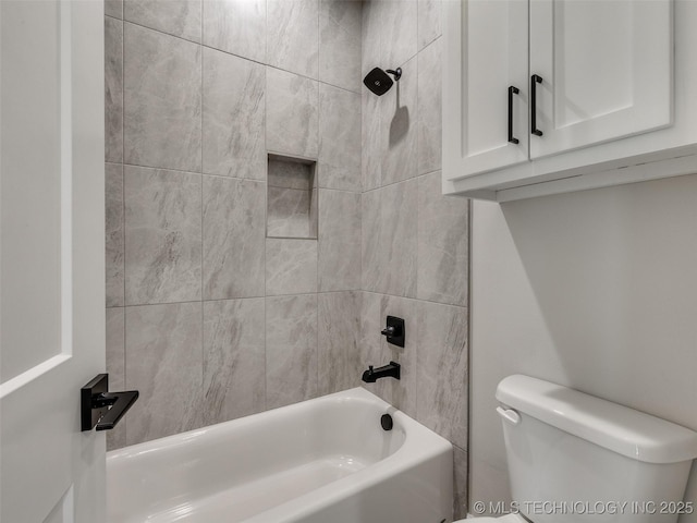 bathroom with toilet and bathing tub / shower combination