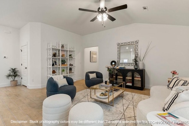 living room featuring light wood finished floors, lofted ceiling, visible vents, ceiling fan, and baseboards