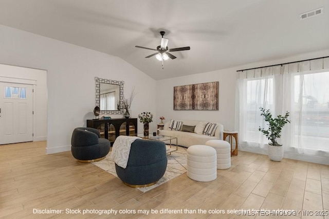 living room with lofted ceiling, ceiling fan, light wood-style flooring, visible vents, and baseboards