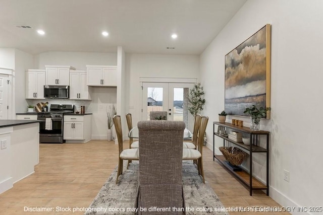 dining space with french doors, recessed lighting, visible vents, light wood-style floors, and baseboards